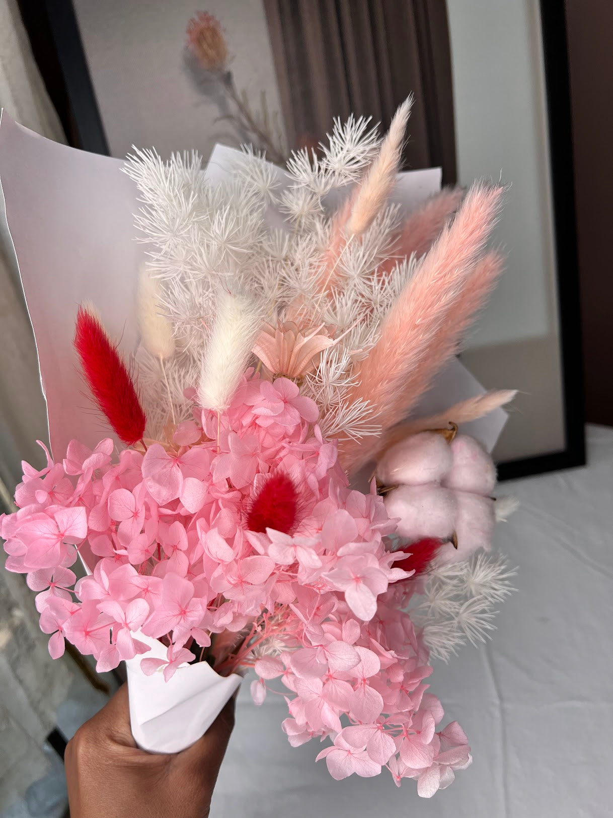 Pink flowers posy bouquet with held by hand. dried preserved flowers posy pampas grass kenya from kenyan lady fleur