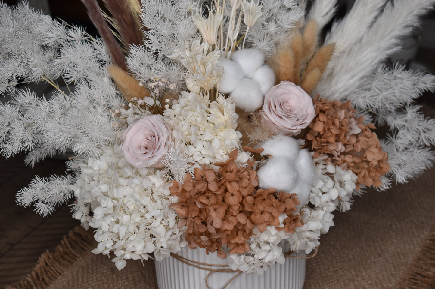 The Issadora muted nude colours preserved flower arrangement from kenyan lady fleur in a 16.5 diameter and 14.5 height white minimalist vase.