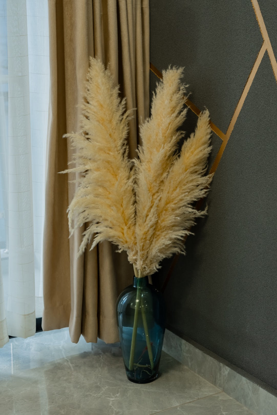 Beige pampas grass from Kenyan Lady Fleur, dried flowers store set up in a glass floor vase. Bulky