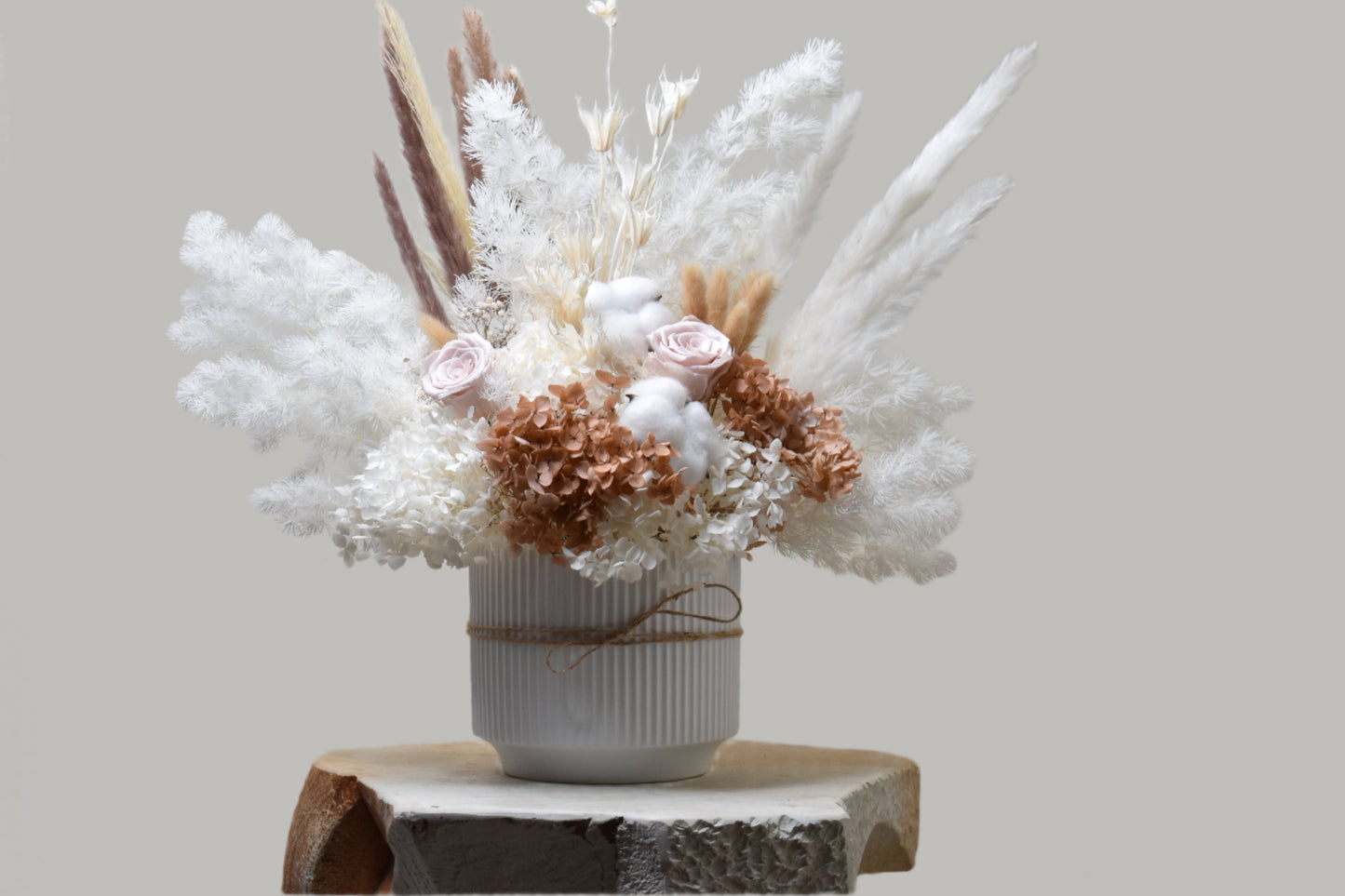 The Issadora muted nude colours preserved flower arrangement from kenyan lady fleur in a 16.5 diameter and 14.5 height white minimalist vase.