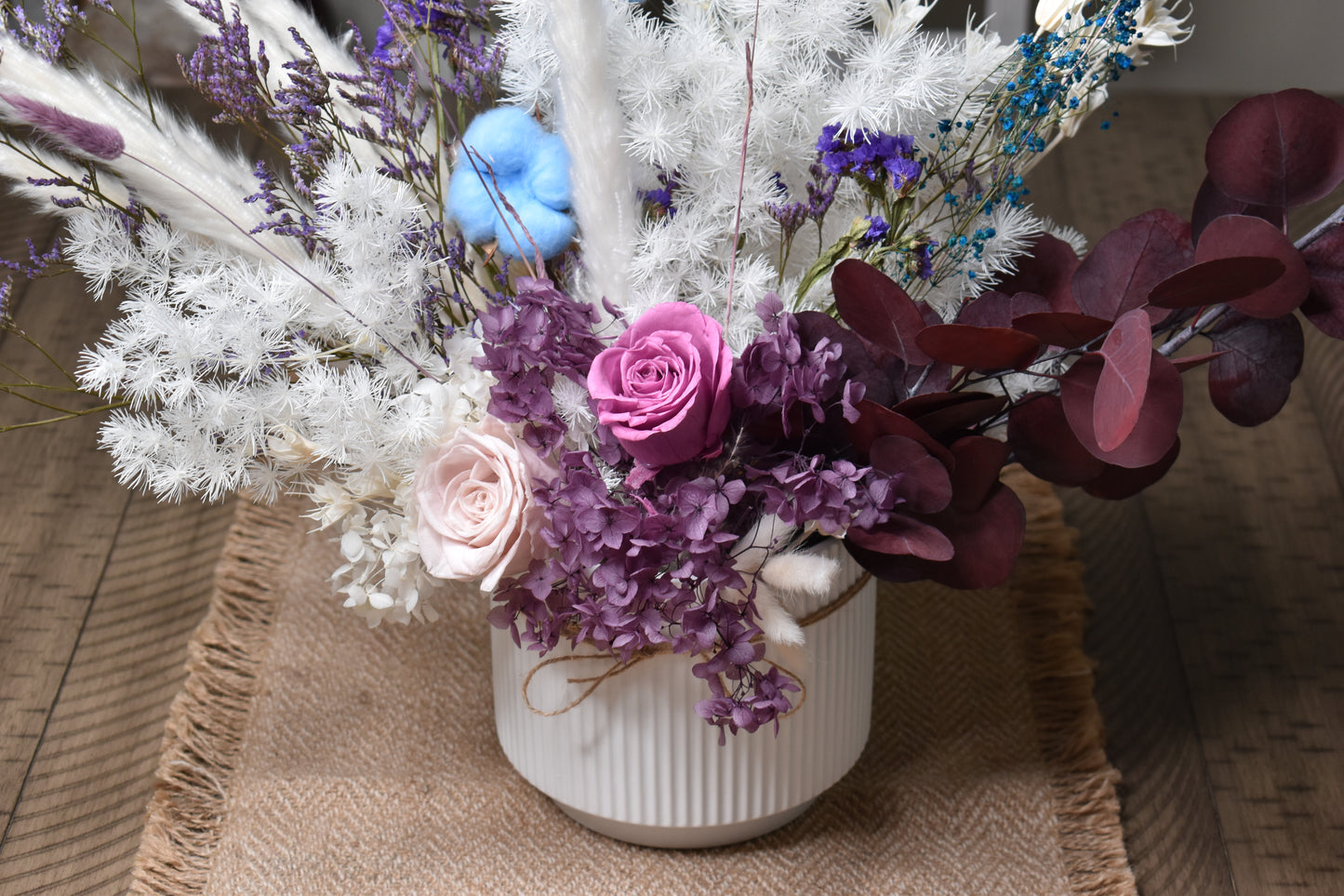 Dried flowers arrangement set on a 6-seater dining table in a 16.5 cm diameter and 14.5 cm height white vase.