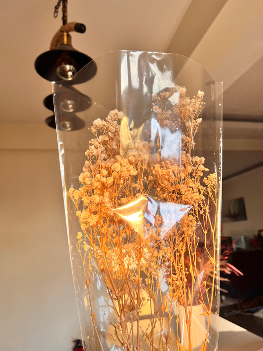 Dried floral arrangement featuring a large cascading bunch of cream white preserved baby's breath from kenyan lady fleur of dried flowers kenya in colourless packaging. 