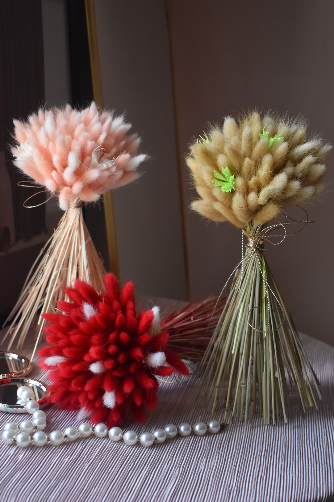 Pink, red, white, and beige Bunny tail grass bouquets from kenyan lady fleur dried flowers shop.