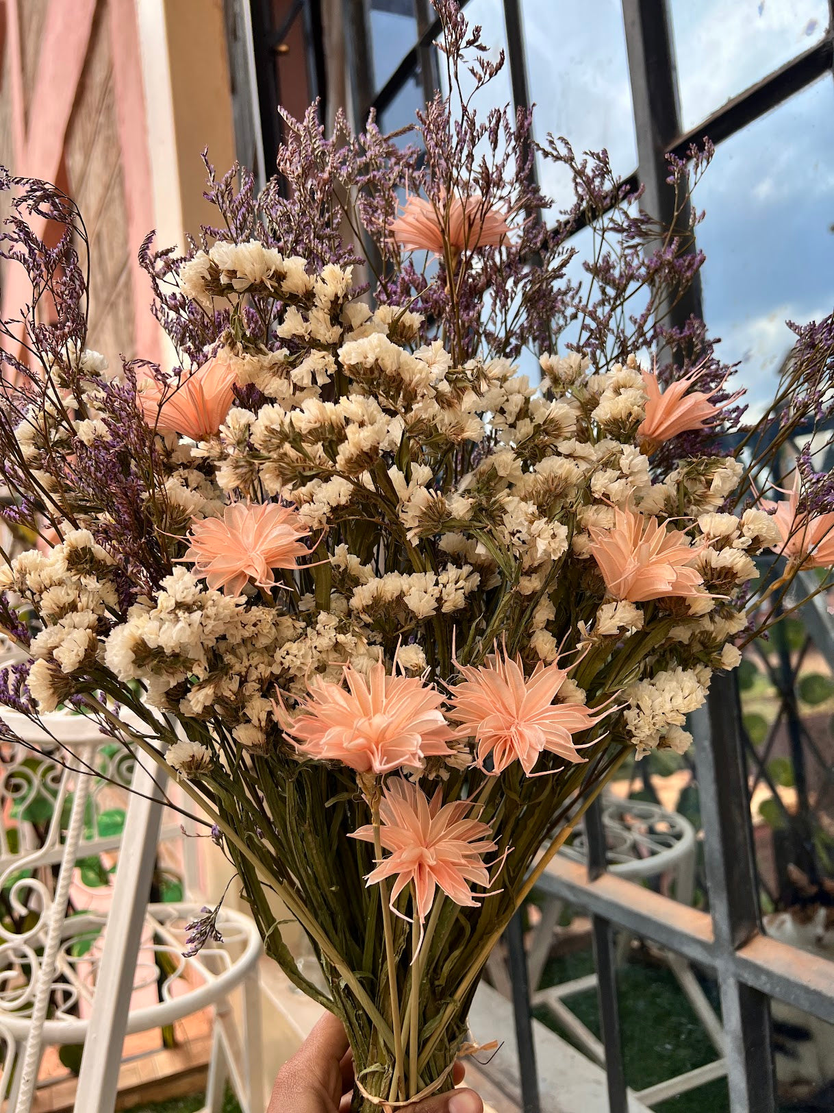 Dried flower bouquet made of white statice, purple caspia, and Star Anise in peach from kenyan lady fleur