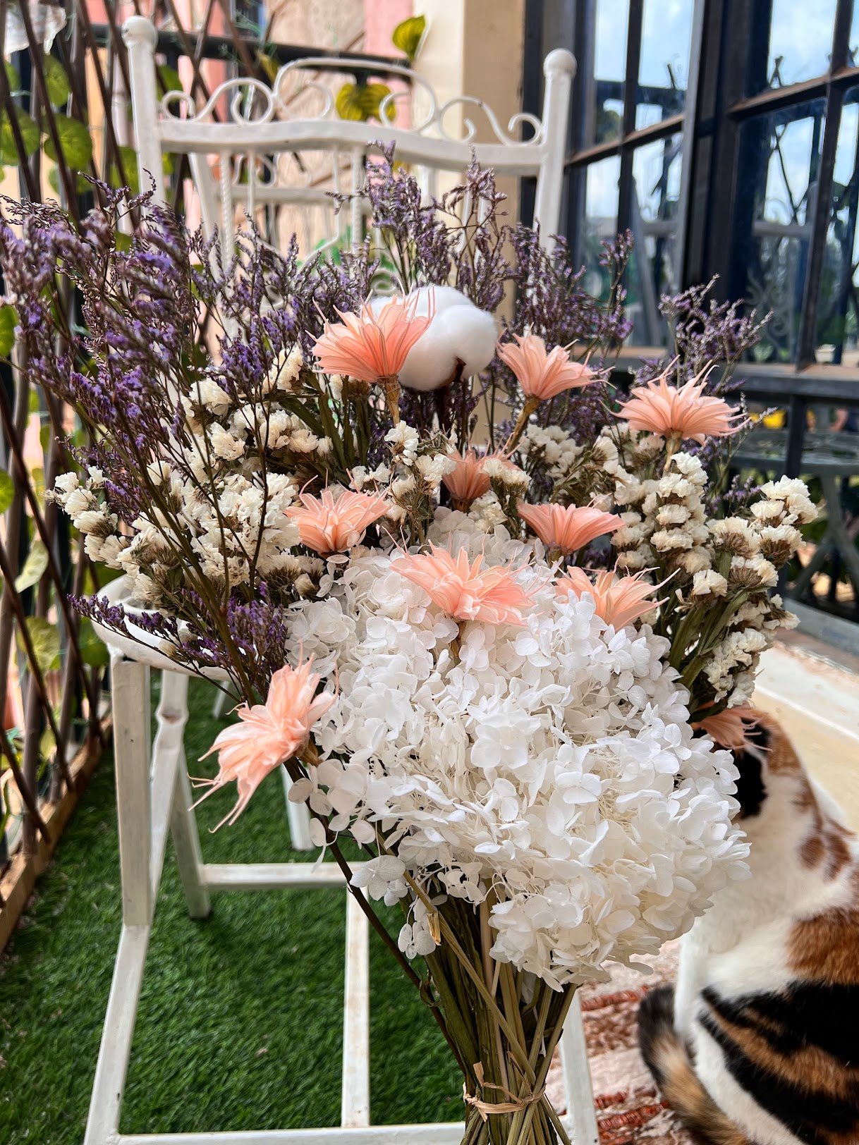 Bouquet of flowers with pink and white preserved flowers on a chair