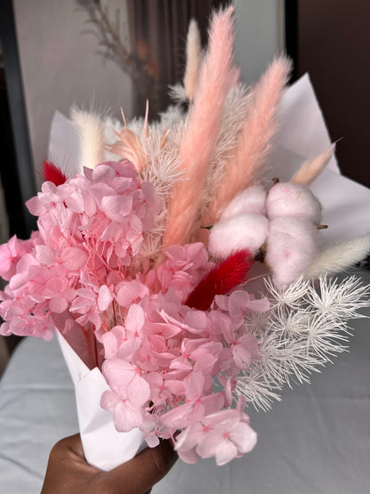 Pink flowers posy bouquet with held by hand. dried preserved flowers posy.
