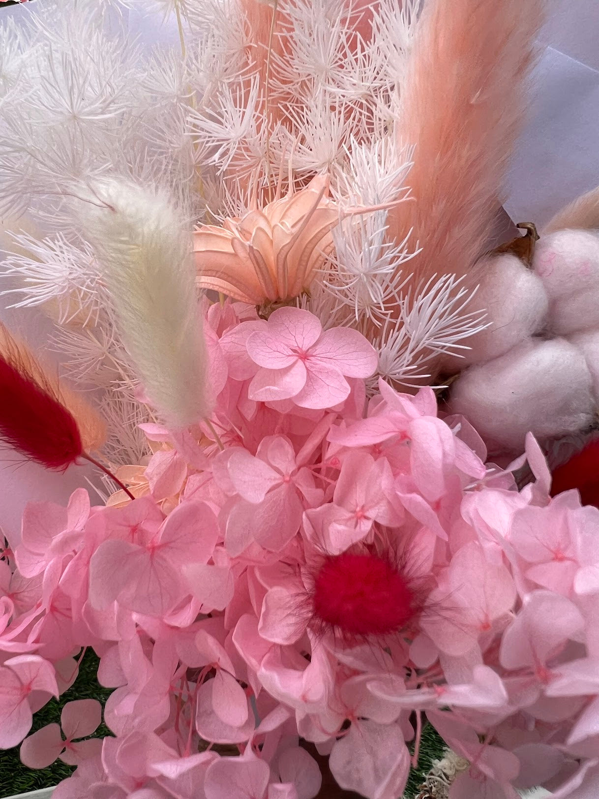 Pink flowers posy bouquet with held by hand. dried preserved flowers posy dried flowers kenya.