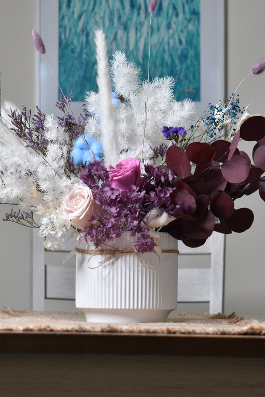 The Christine Dried flowers arrangement for your dining, dressing, or lobby table on a 16.5 cm diameter and 14.5 cm height white vase.