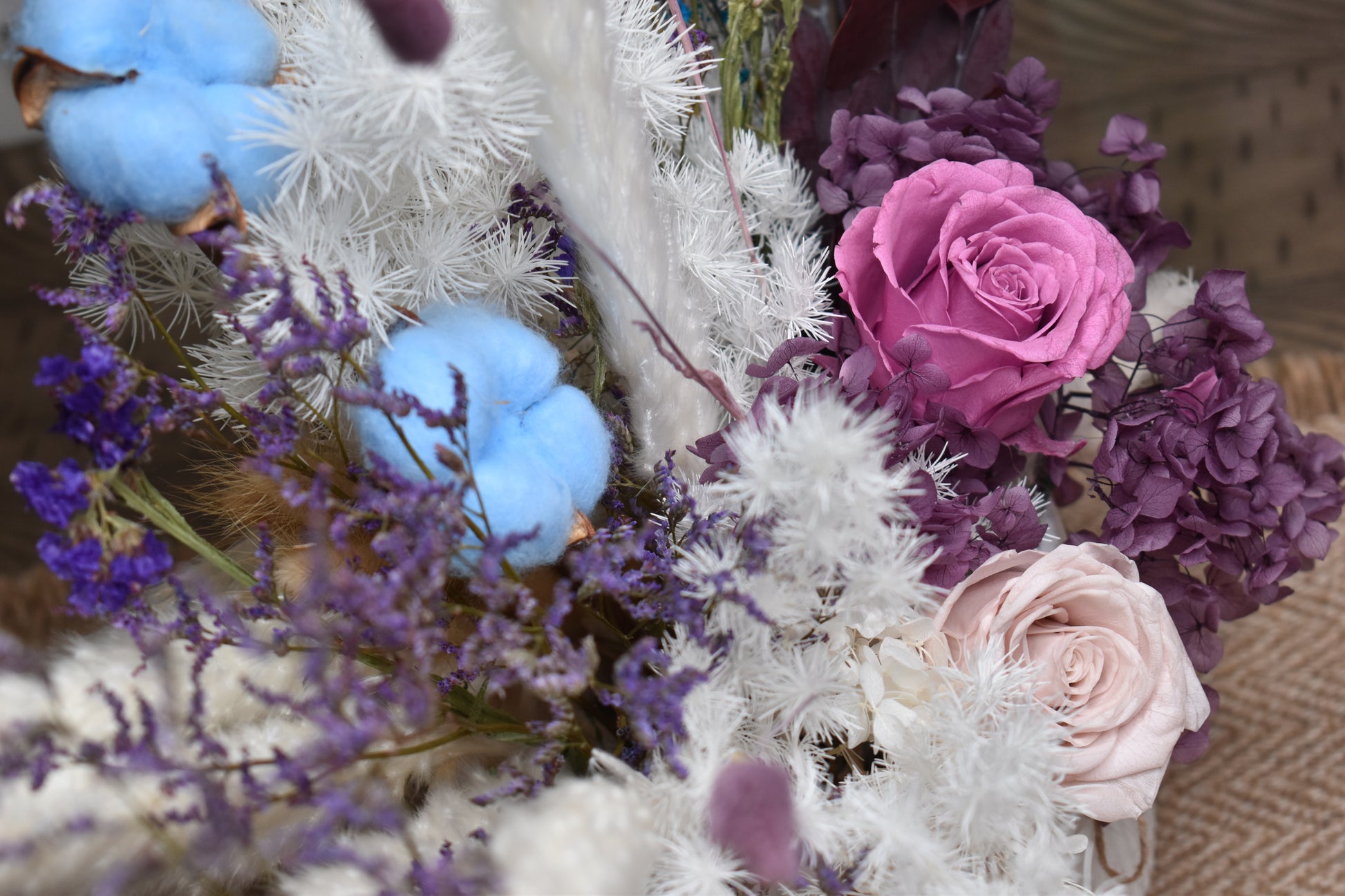 Dried flowers arrangement set on a 6-seater dining table in a 16.5 cm diameter and 14.5 cm height white vase from kenyan lady fleur.